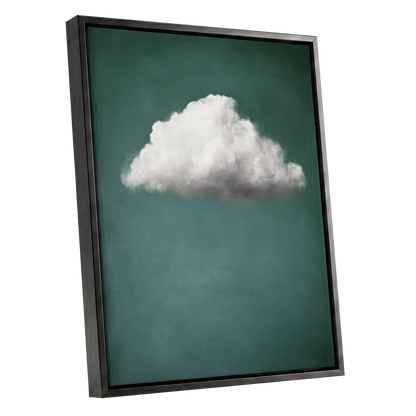 A framed wall art print featuring a single white cloud against a deep teal-green background, shown at an angle with a black floating frame on a white studio background.