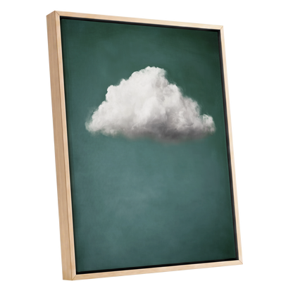 Framed wall art featuring a single white cloud centered on a dark teal-green background, shown in a light natural wood frame against a plain white backdrop.