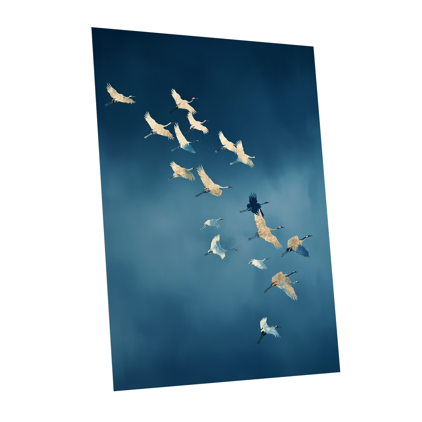 A vertical wall art print showing a flock of white cranes flying against a deep blue sky, displayed at an angle on a white background.