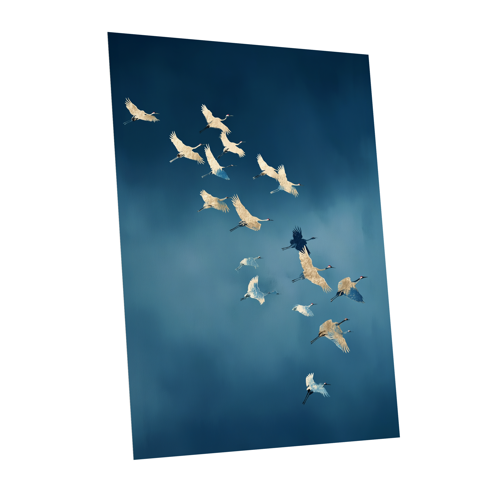 A vertical wall art print showing a flock of white cranes flying against a deep blue sky, displayed at an angle on a white background.