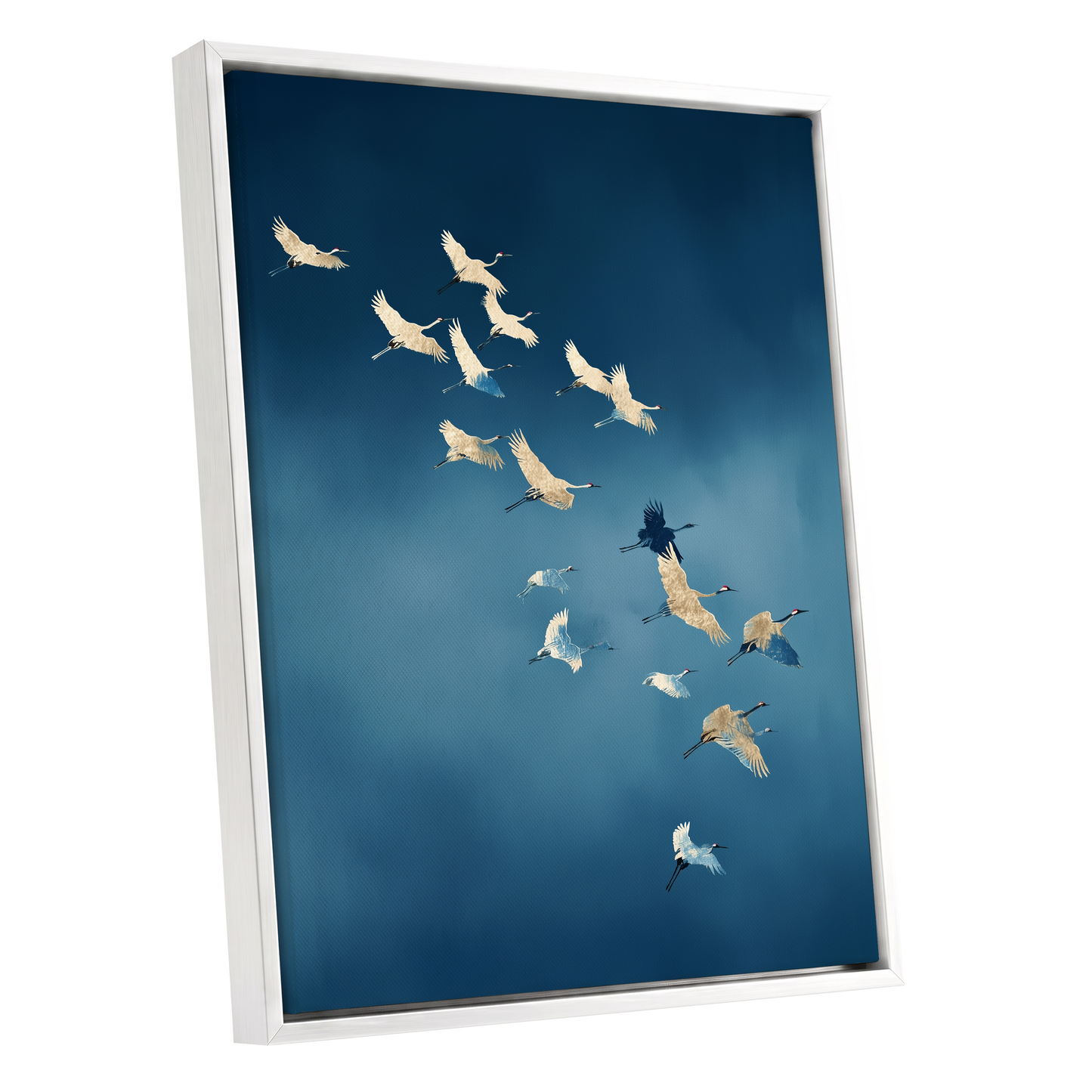 A framed vertical canvas print featuring a flock of cranes flying against a deep blue sky, shown at an angle with a white frame on a white background.