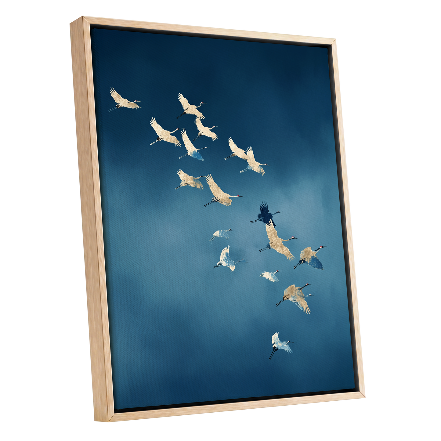 A framed wall art print depicting a flock of cranes flying across a deep blue sky, shown in a light natural wood frame against a white background.
