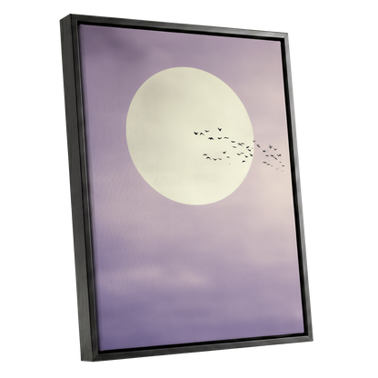 Framed wall art featuring a large cream full moon against a lavender-purple sky with a flock of small birds flying across it, shown in a black frame on a white background.