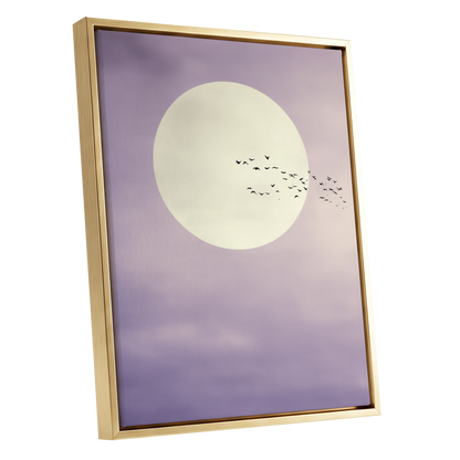 A framed art print featuring a large cream-colored moon against a soft lavender-purple sky with a flock of small birds flying across it, enclosed in a thin gold frame.