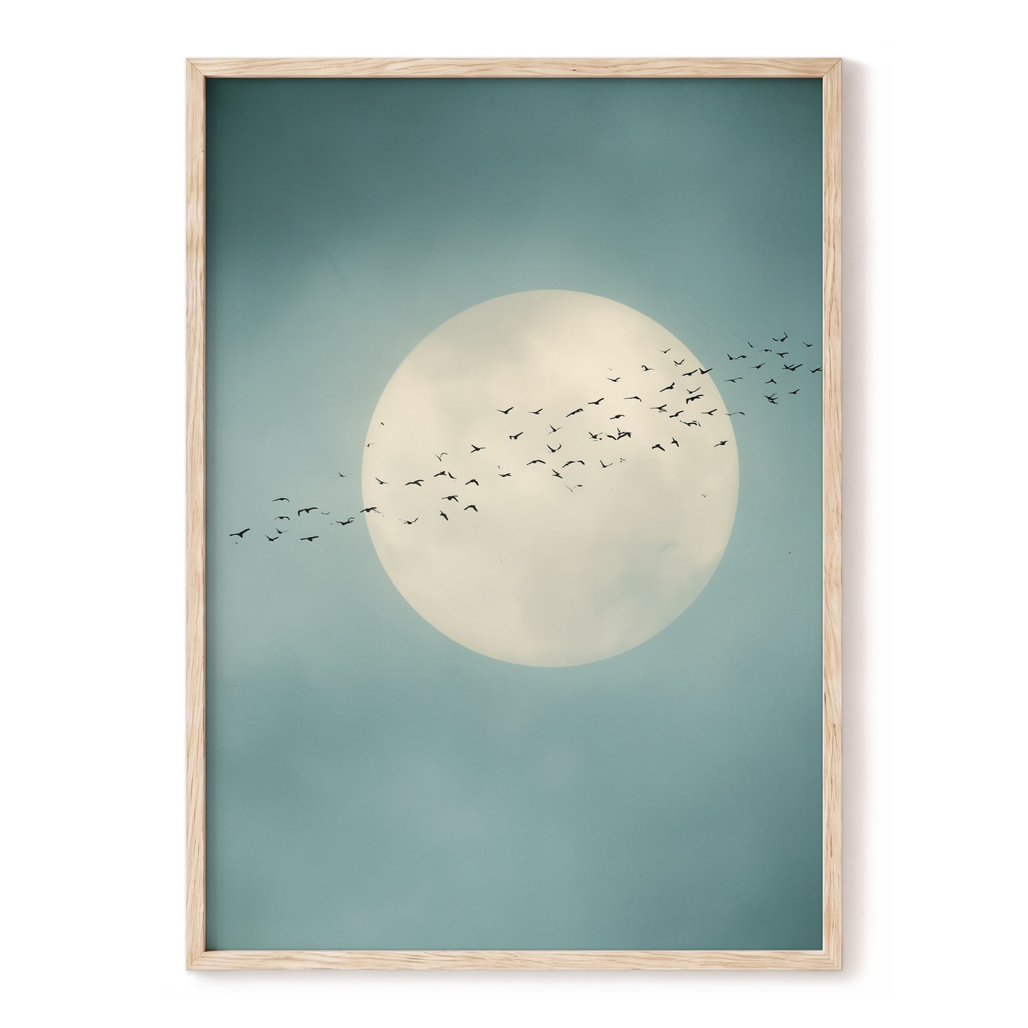 Framed wall art featuring a large cream moon and a flock of birds against a muted teal sky, shown in a light natural wood frame on a white background.