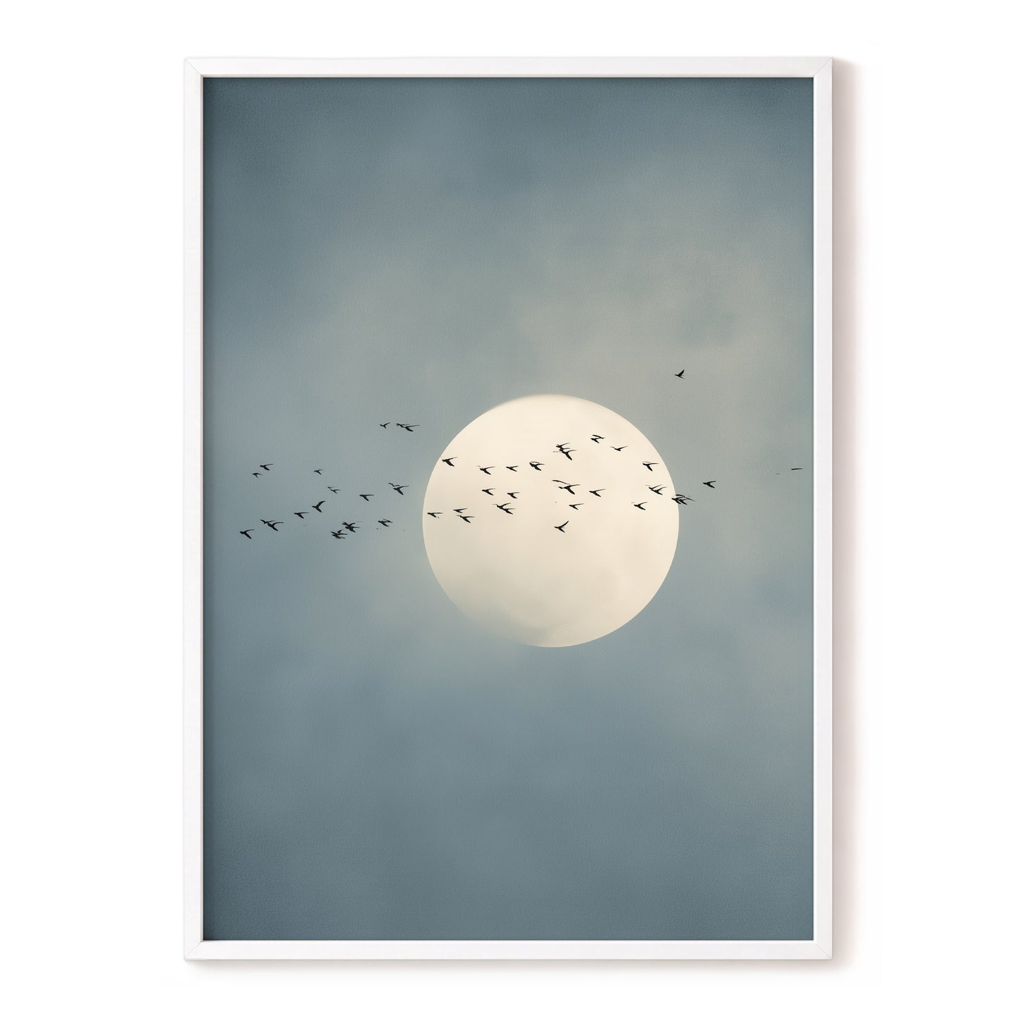 A framed art print featuring a large pale moon in a cloudy blue-gray sky, with a flock of birds flying around it. The print is presented in a thin white frame against a clean white background.