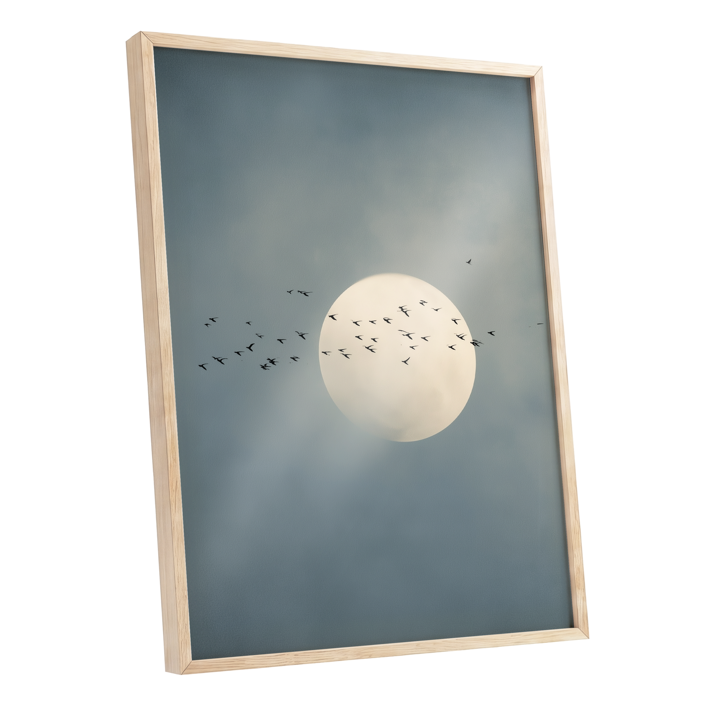 Framed wall art featuring a pale full moon with small black bird silhouettes against a muted blue-gray cloudy sky, shown in a light natural wood frame on a white background.