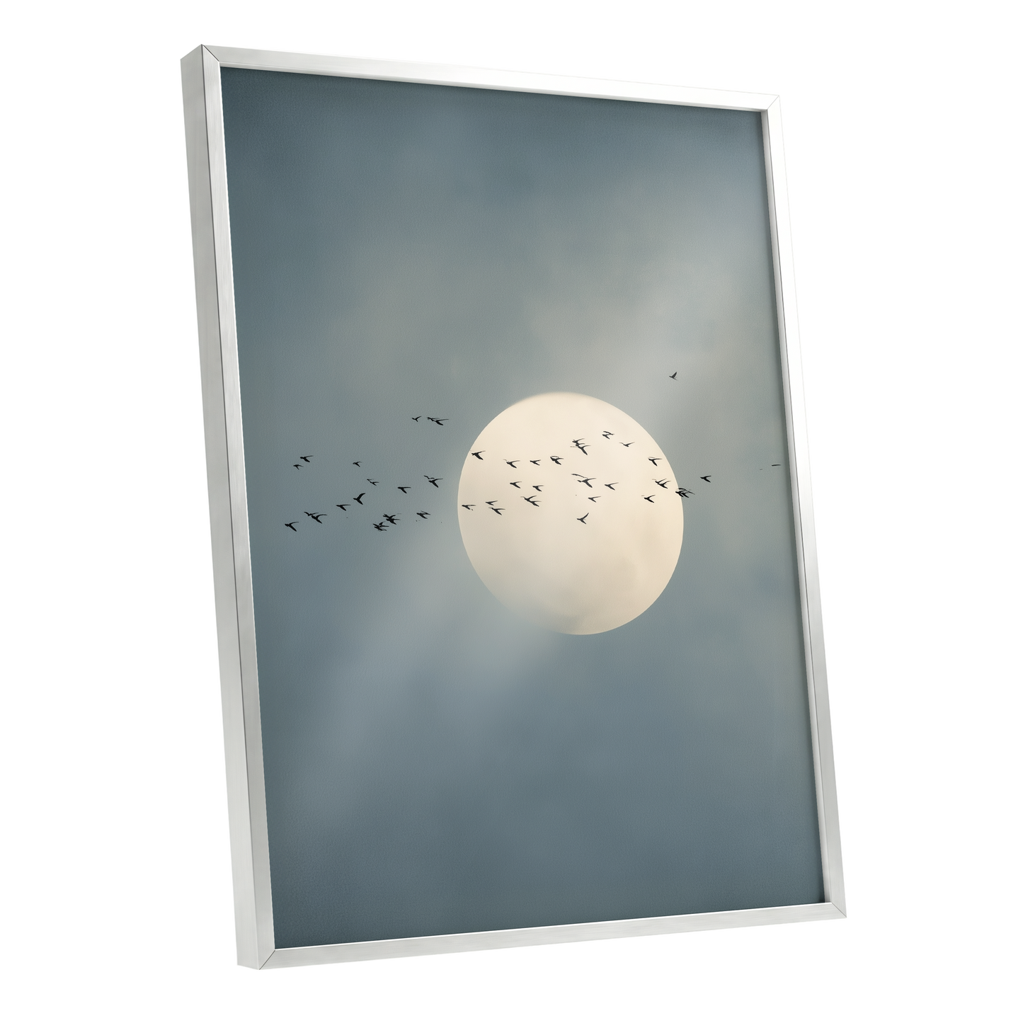 A framed wall art print showing a pale full moon against a smoky blue-gray sky with small black birds flying across it, presented in a white frame on a light gray background.