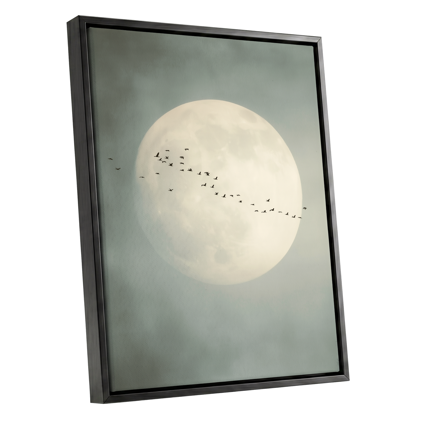 Framed wall art featuring a large pale full moon against a muted gray-green sky, with a small flock of birds across the center. The artwork is shown in a black frame at a slight angle on a plain white background.