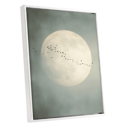 Framed wall art featuring a large pale moon in a misty gray-green sky with a small flock of birds across the center, shown in a white frame against a light gray background.