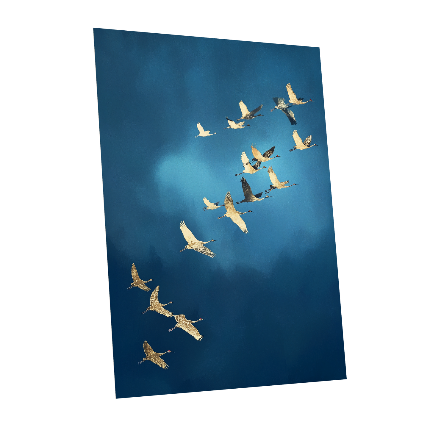 A vertical photographic print of a flock of cranes flying in a V-formation against a deep blue sky, shown as a mockup on a white background.