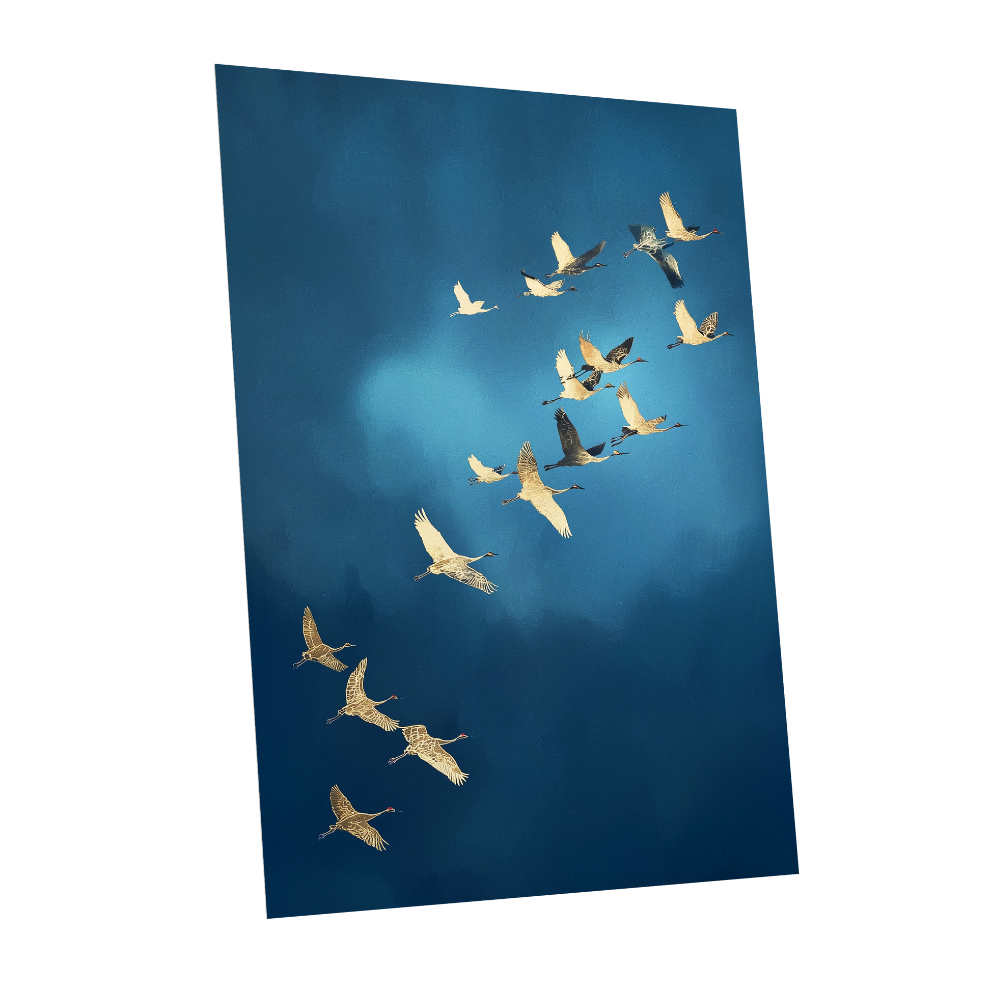 A vertical photographic print of a flock of cranes flying in a V-formation against a deep blue sky, shown as a mockup on a white background.