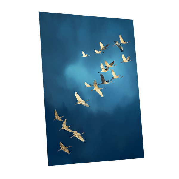 A vertical photographic print of a flock of cranes flying in a V-formation against a deep blue sky, shown as a mockup on a white background.