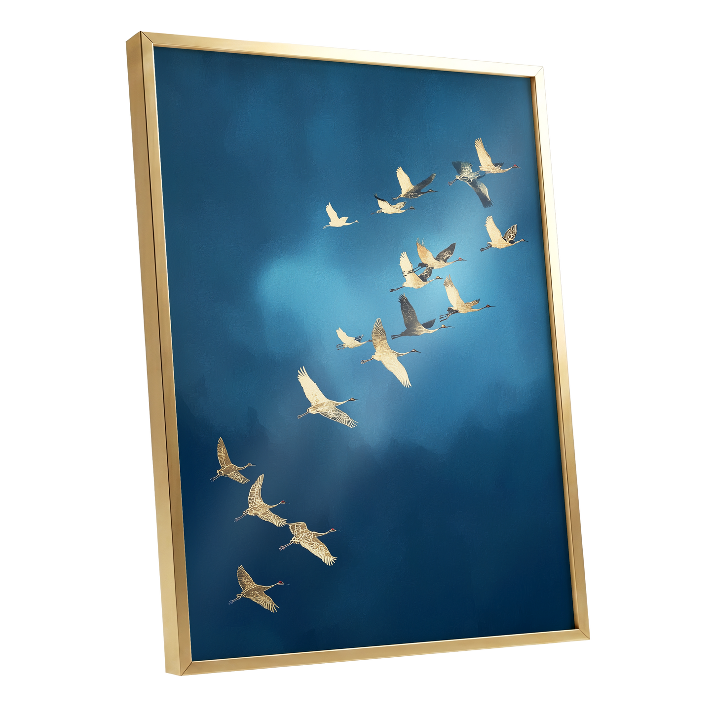 Framed wall art featuring a flock of white cranes flying across a deep blue sky, shown in a gold frame against a white background.