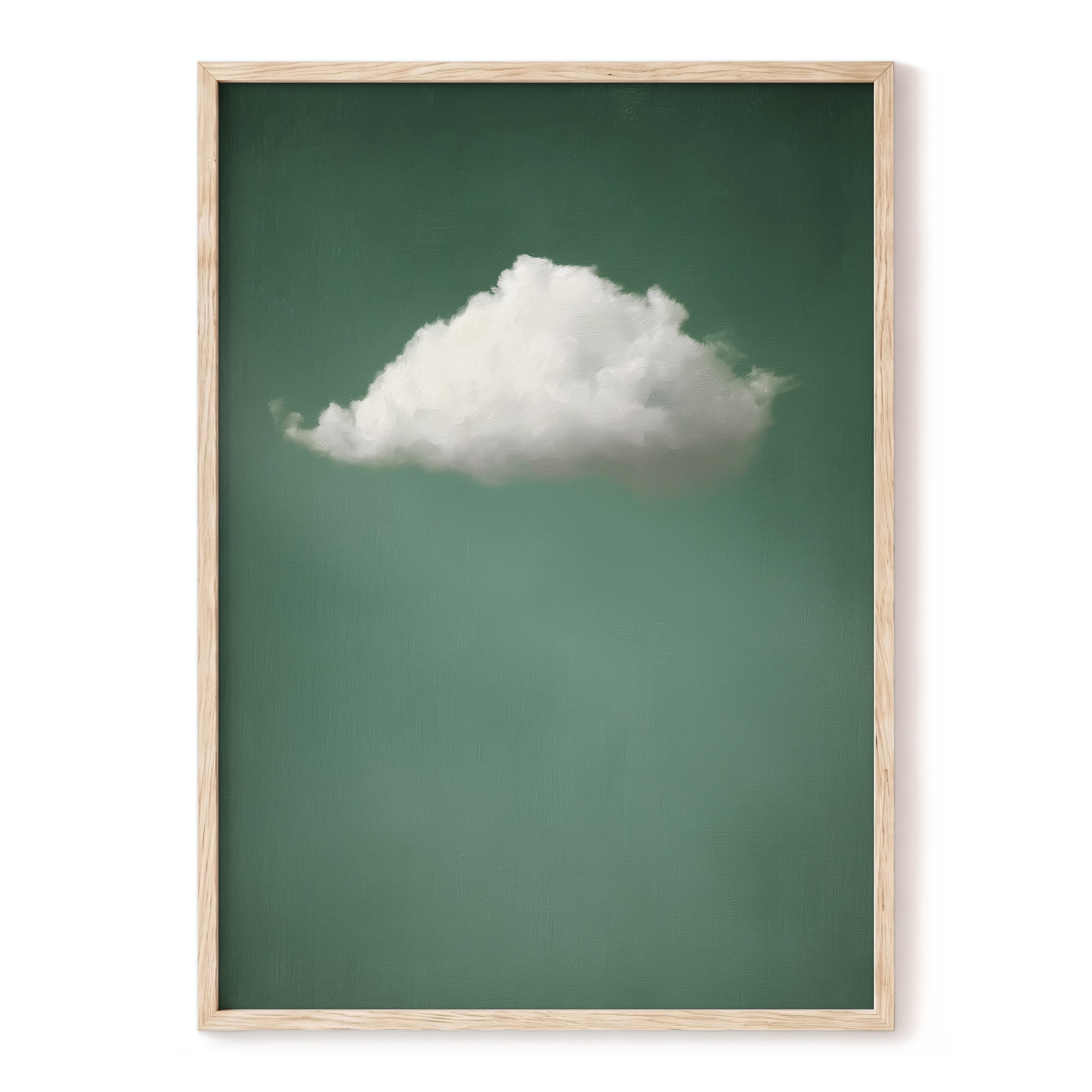 Framed wall art featuring a single white cloud against a muted green background, enclosed in a light natural wood frame and shown against a white wall.