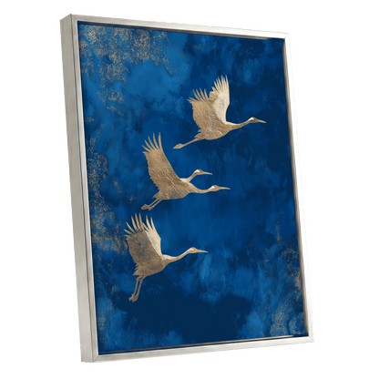 Cranes Across Cobalt, blue, gold, brown nature wall art shown as a silver framed canvas wall art