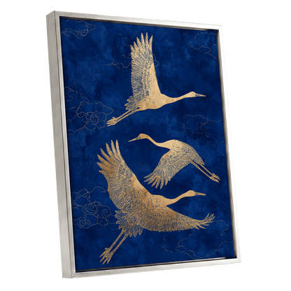 Gilded Cranes in Flight, blue, gold, beige nature wall art shown as a silver framed canvas wall art