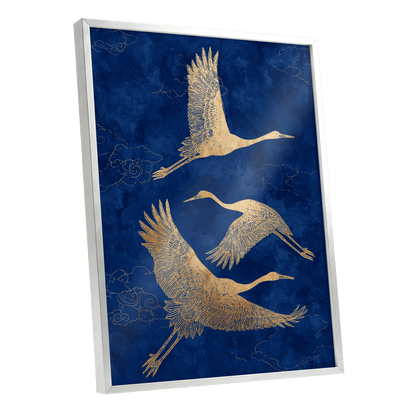 Gilded Cranes in Flight, blue, gold, beige nature wall art shown as a silver framed poster wall art print
