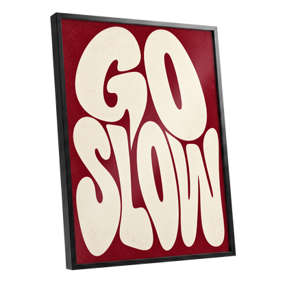 Go Slow Ruby, red, beige abstract wall art shown as a black framed poster wall art print