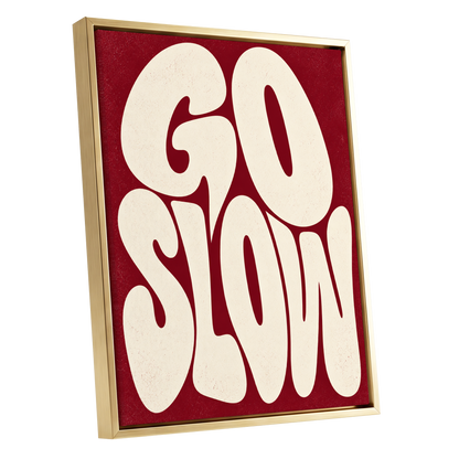 Go Slow Ruby, red, beige abstract wall art shown as a gold framed canvas wall art