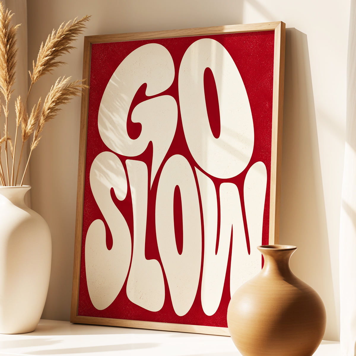 Go Slow Ruby, red, beige abstract wall art displayed in a styled interior, gallery view 2