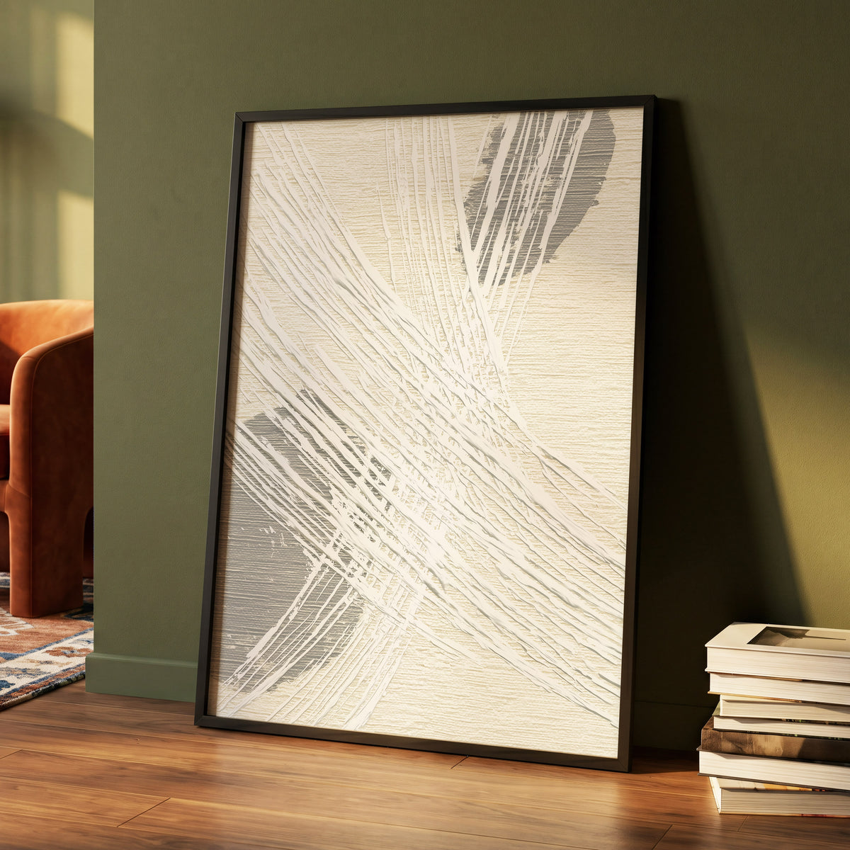 Grey Crosshatch Abstract: a framed abstract art print with textured off-white and gray brushstrokes, leaning against a dark olive green wall on a wooden floor next to a stack of books.