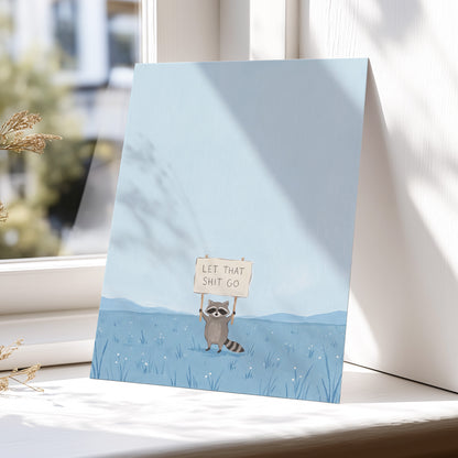 Let It Go Raccoon, blue, beige, gray nature wall art displayed in a styled interior, gallery view 5