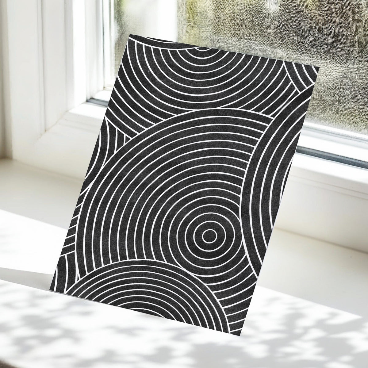 Monochrome Orbit, black, white, gray abstract wall art displayed in a styled interior, gallery view 5
