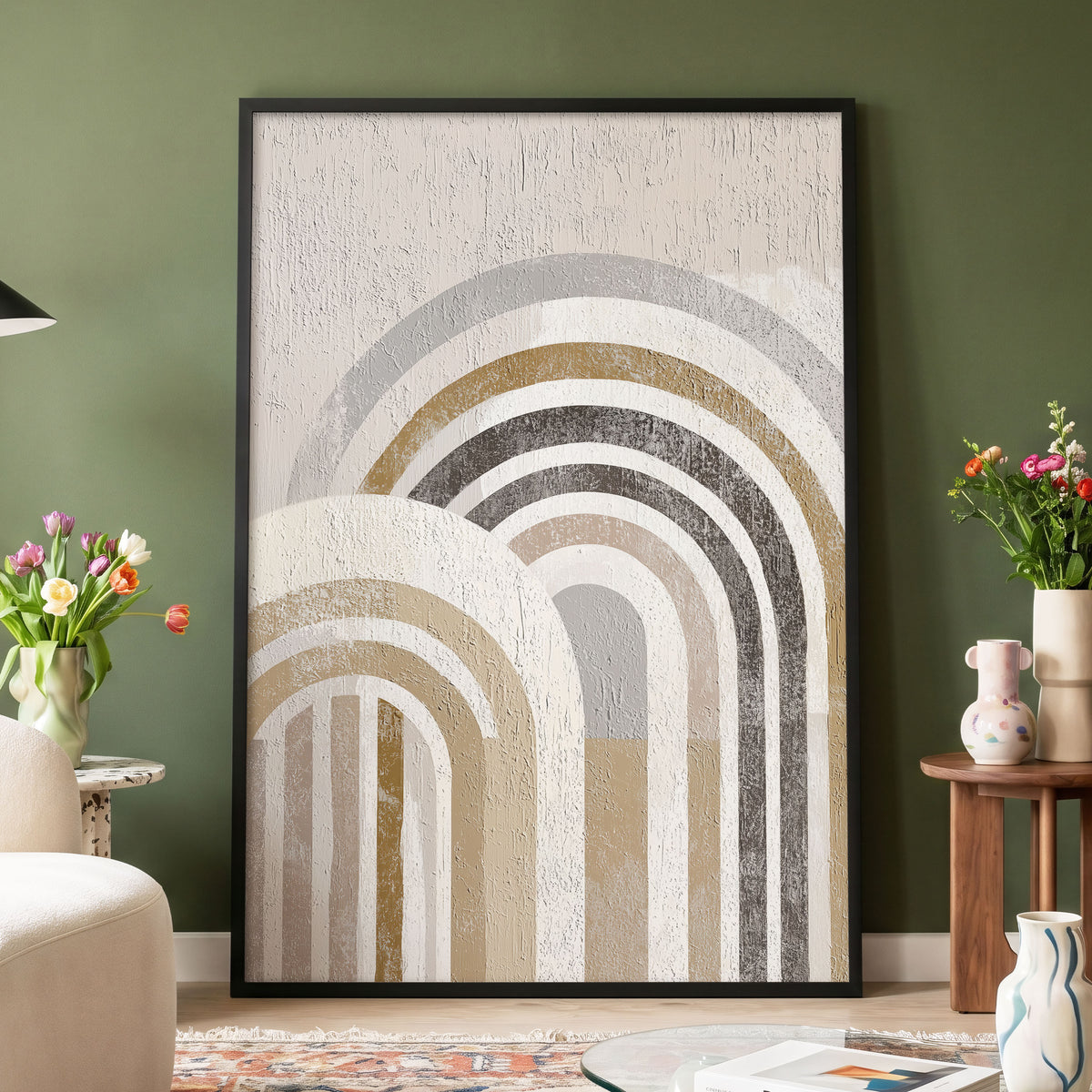 Neutral Rainbow Arches: a large framed wall art print featuring layered arches in beige, gray, white, and muted gold tones, displayed against an olive green wall in a styled living room setting.